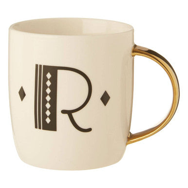 Beige mug with gold handle and black letter &