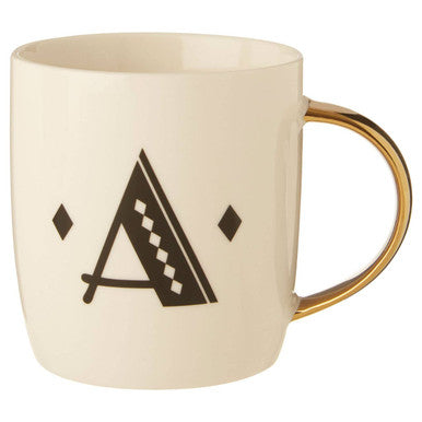 Beige mug with black geometric design and gold handle on a white background
