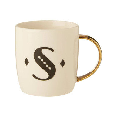 Beige mug with a gold handle and black decorative letter &