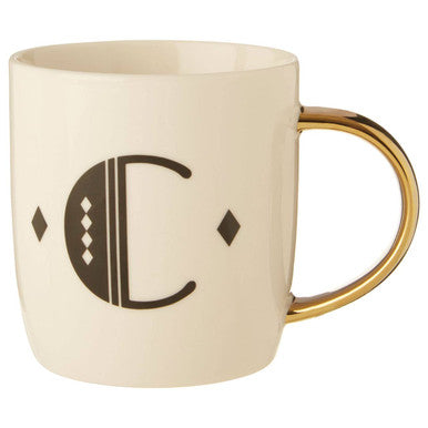 Beige mug with gold handle and decorative letter &