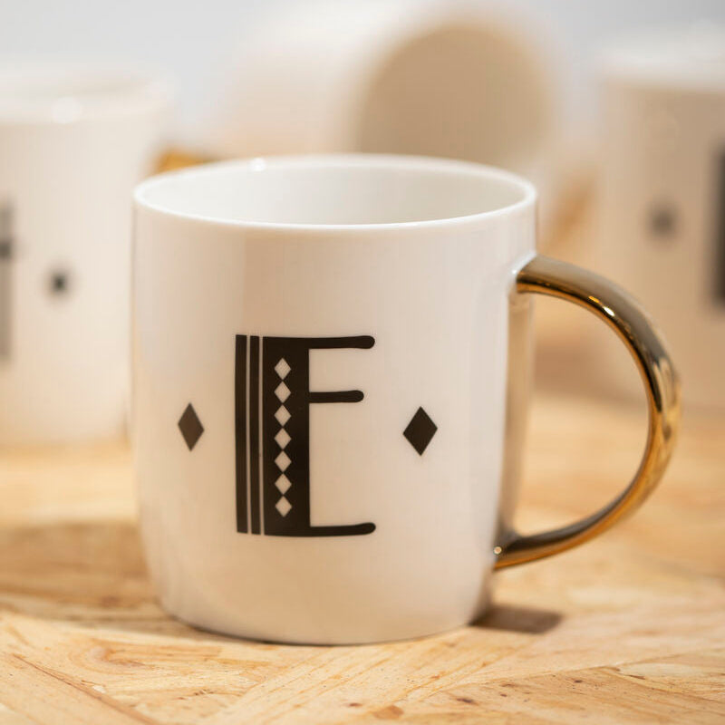 White mug with a black letter &