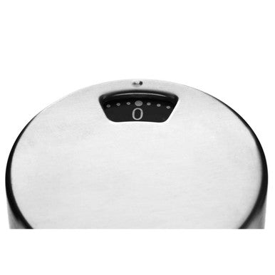 Close-up of a white electronic device with a black dial on a white background