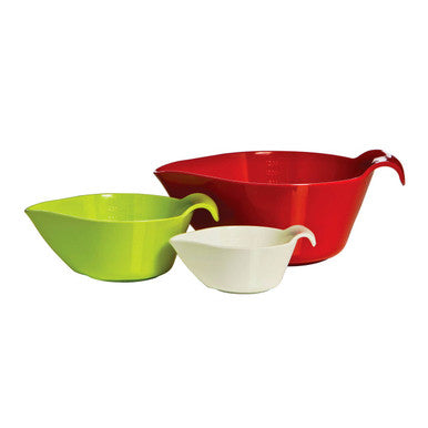Three colorful bowls in green, red, and white on a white background