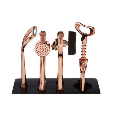 Set of rose gold bar tools on a black stand against a white background