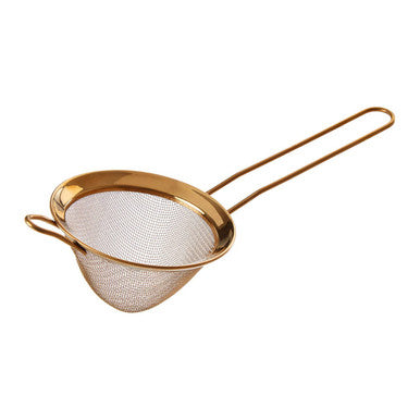 Gold mesh strainer on a white background