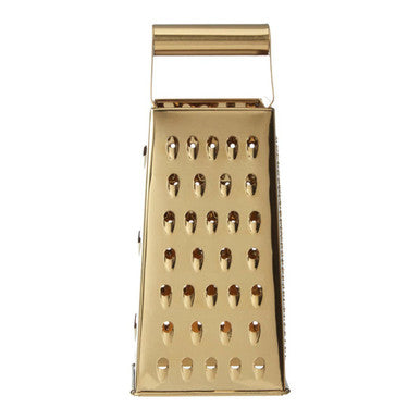 Gold metal box grater on a white background