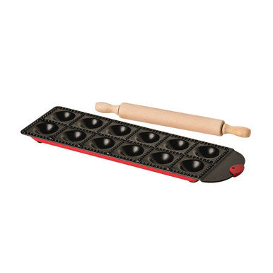 Baking tray with round molds and a wooden rolling pin on a white background