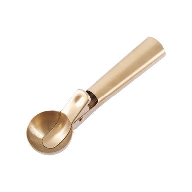 Gold ice cream scoop on a white background