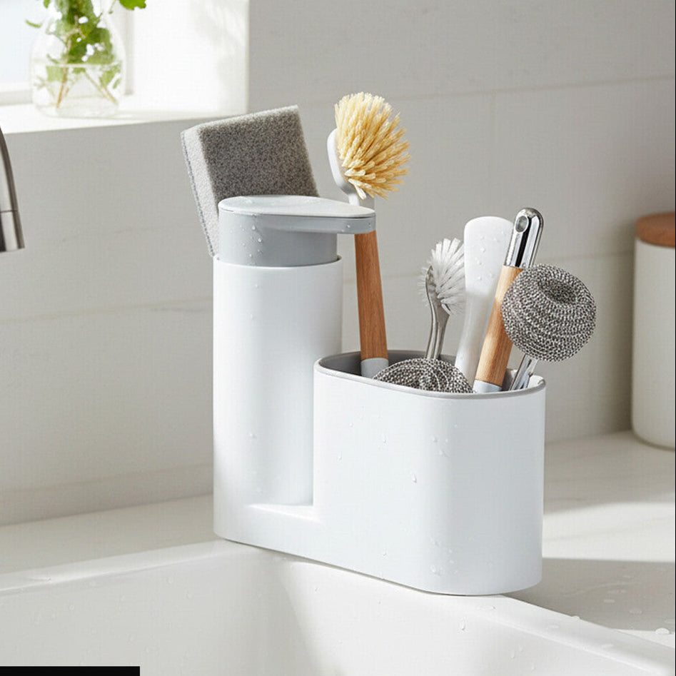 White kitchen utensil holder with cleaning tools on a kitchen counter