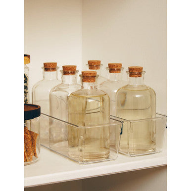 Set of glass bottles with cork lids on a shelf