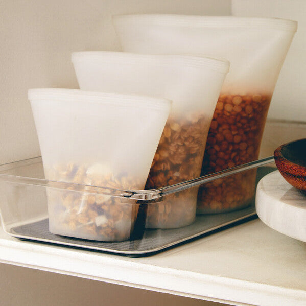 Clear plastic containers with food on a shelf