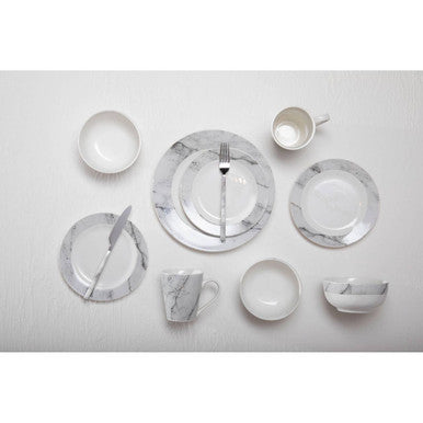 Set of marble-patterned ceramic dinnerware on a white background