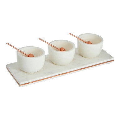 Set of three ceramic bowls with wooden spoons on a white tray