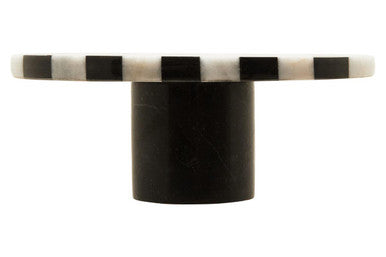 Black and white striped cylindrical object on a white background