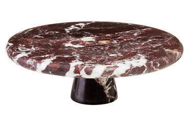 Round marble table with a dark brown and white pattern on a white background