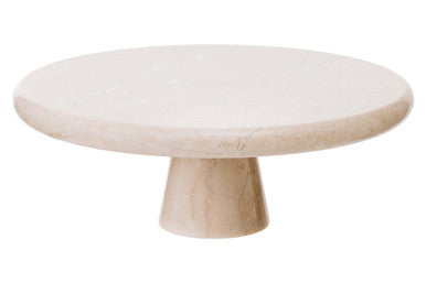 Round marble table with a single leg on a white background