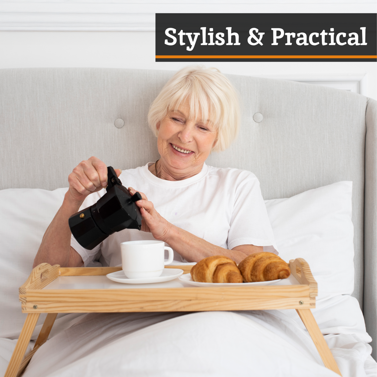Woman in bed with a breakfast tray holding a black device, with text &