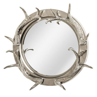 Round mirror with antler-like frame on a white background