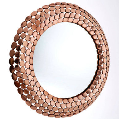 Round mirror with a decorative copper shell-like frame on a white background