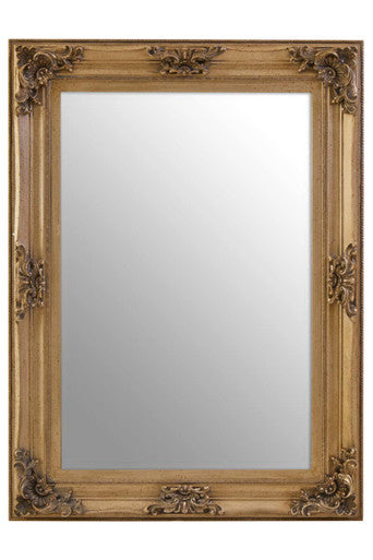 Decorative mirror with ornate gold frame on a white background