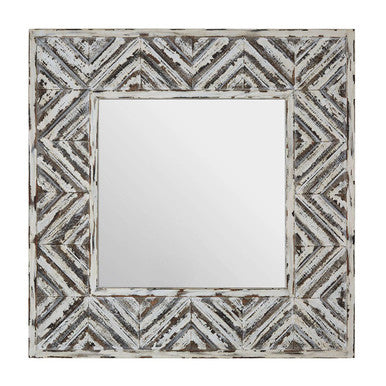 Decorative mirror with geometric patterned frame on a white background