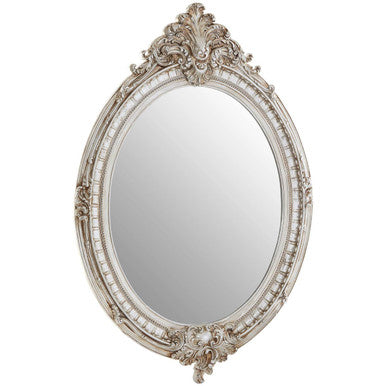 Decorative oval mirror with intricate silver frame on a white background