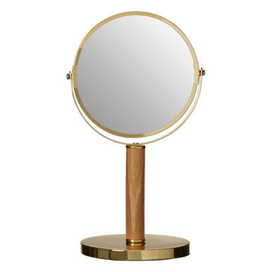 Tabletop mirror with gold frame and wooden base on a white background