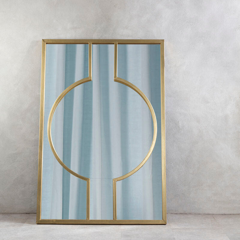 Decorative mirror with gold frame and blue glass on a gray wall.