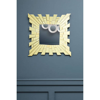 Decorative mirror with a geometric frame on a blue wall