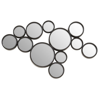 Wall art made of circular mirrors in black and silver on a white background