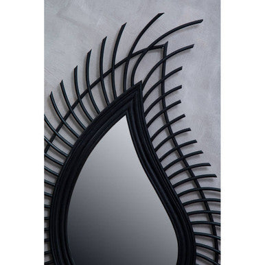 Decorative wall mirror with black metal frame on a light gray background