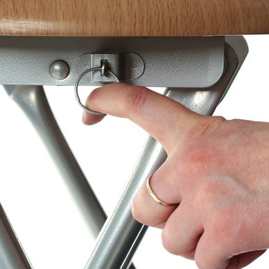 Hand adjusting a metal bracket on a wooden surface
