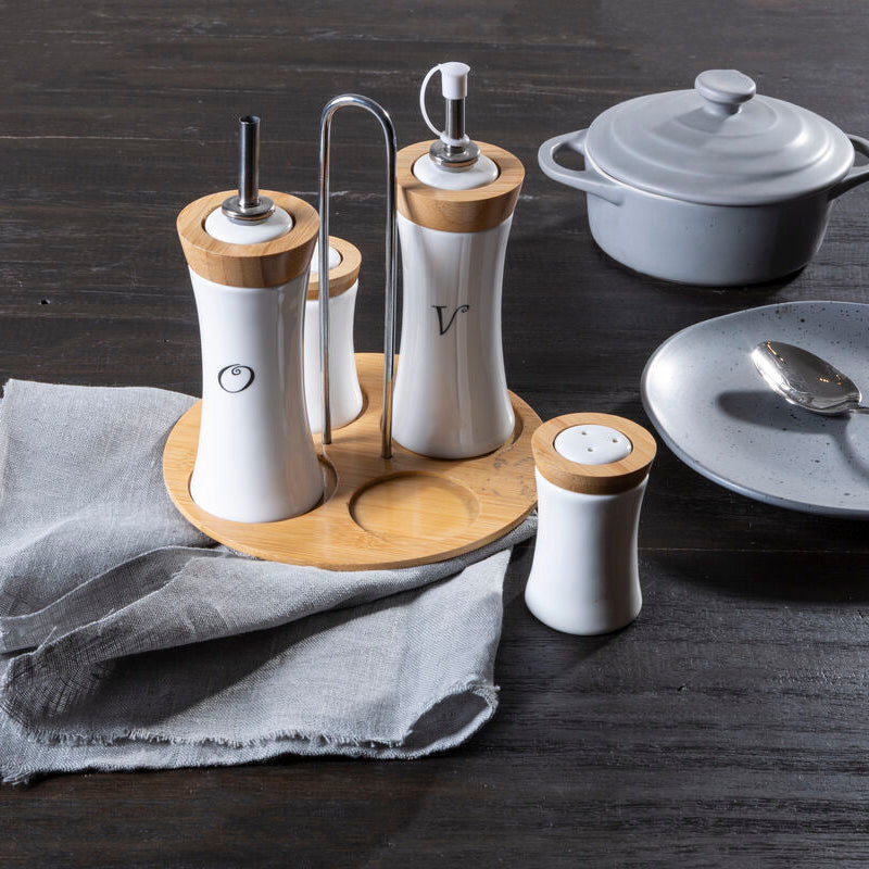 Table setting with salt and pepper shakers, a plate, and a spoon on a wooden surface.