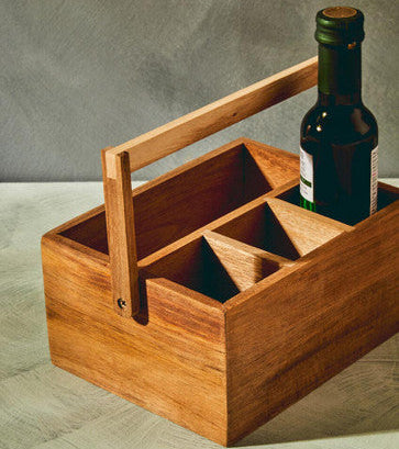 Wooden drink carrier with a bottle inside on a gray surface