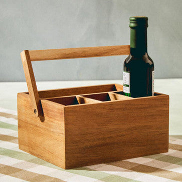 Wooden bottle carrier with a green bottle on a checkered tablecloth