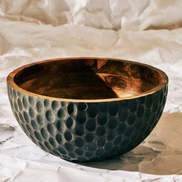 Decorative bowl with textured surface on a textured beige background