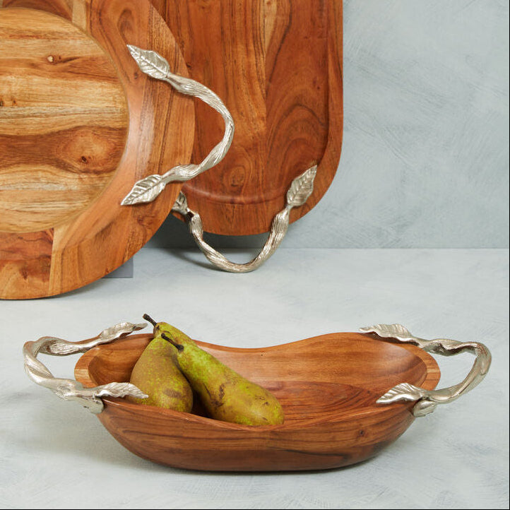 Wooden serving trays with silver leaf handles on a light gray background
