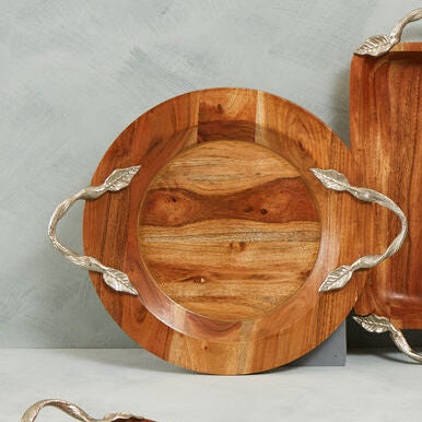 Set of wooden serving trays with metal handles on a gray background