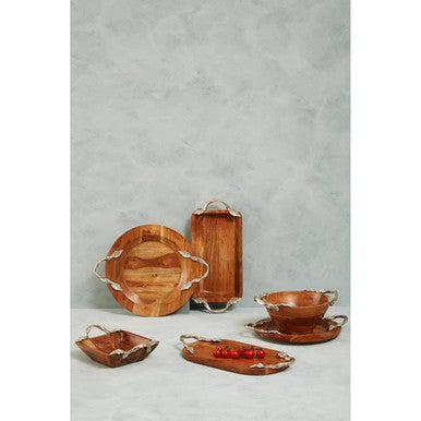 Set of wooden serving trays and bowls on a gray background