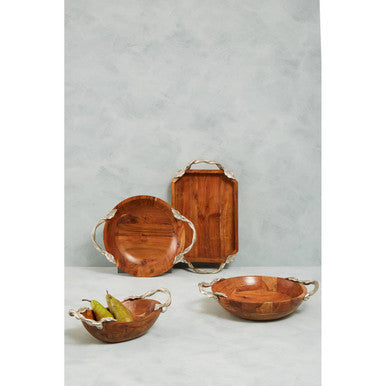 Set of wooden serving trays and bowls on a light gray background