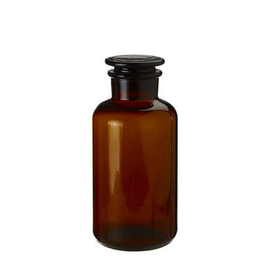 Brown glass bottle with black cap on a white background
