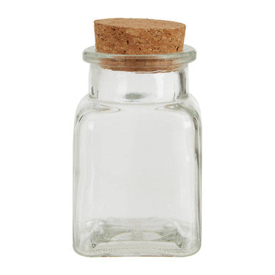 Clear glass jar with a cork lid on a white background