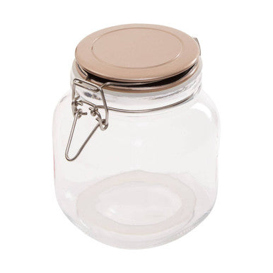 Clear glass jar with a beige lid on a white background