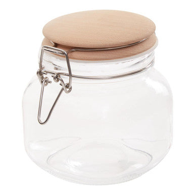Clear glass jar with a wooden lid on a white background