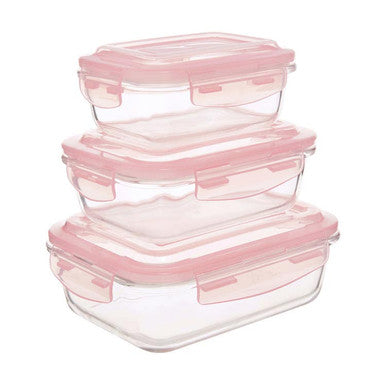 Set of glass food storage containers with pink lids on a white background