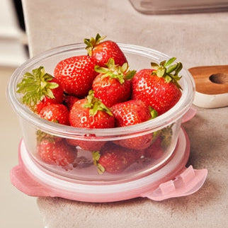 Strawberries in a pink container on a beige surface