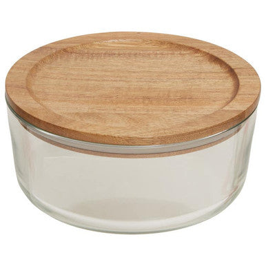 Glass container with a wooden lid on a white background
