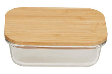 Glass food container with a wooden lid on a white background