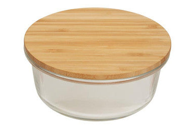 Glass container with a wooden lid on a white background