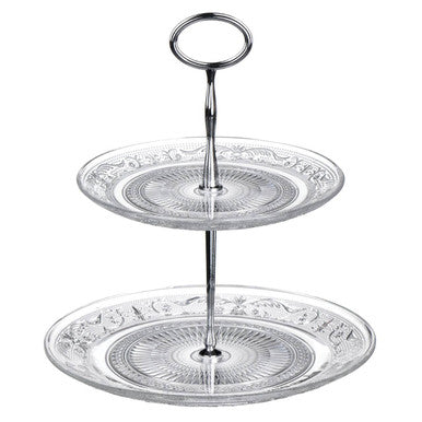 Two-tiered glass cake stand with decorative patterns on a white background